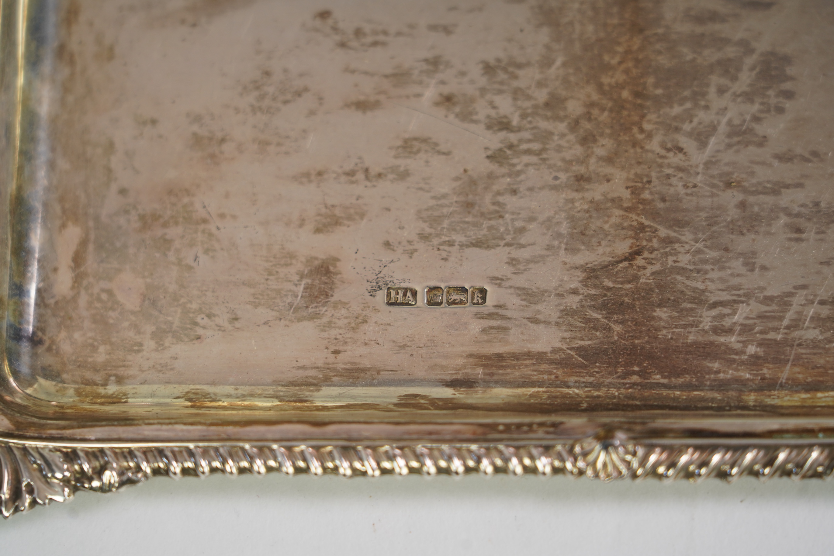 An Edwardian cased silver small two handled serving tray with six matching silver mounted glass liqueur tots, by Atkin Brothers